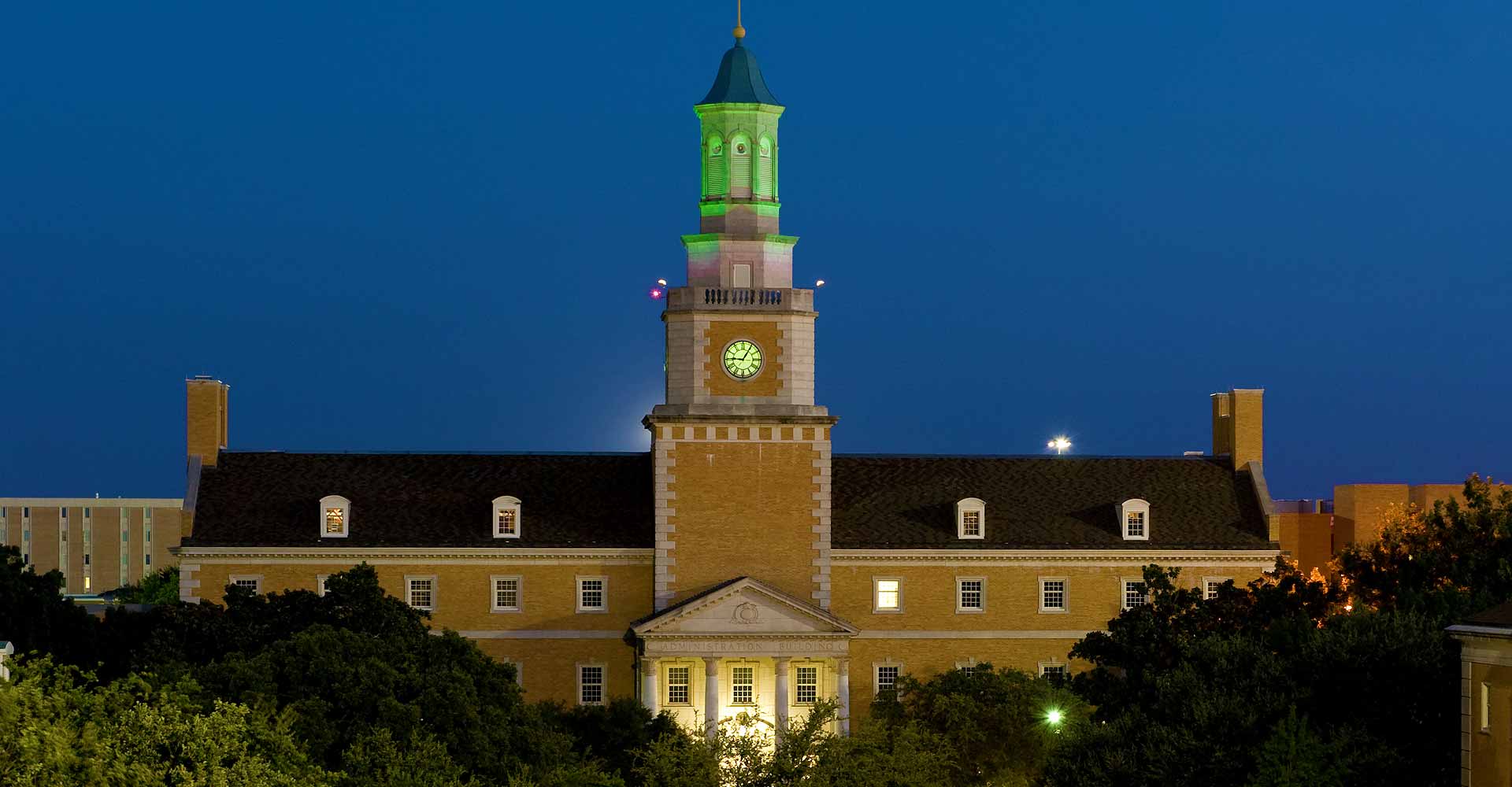 The UNT Administration Building's tower is lit green after Mean Green victories.